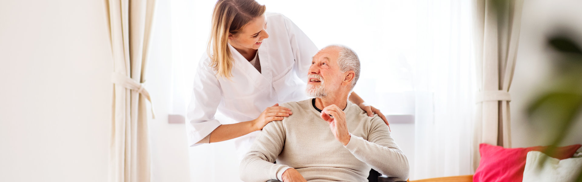 woman looking at elderly man sitting