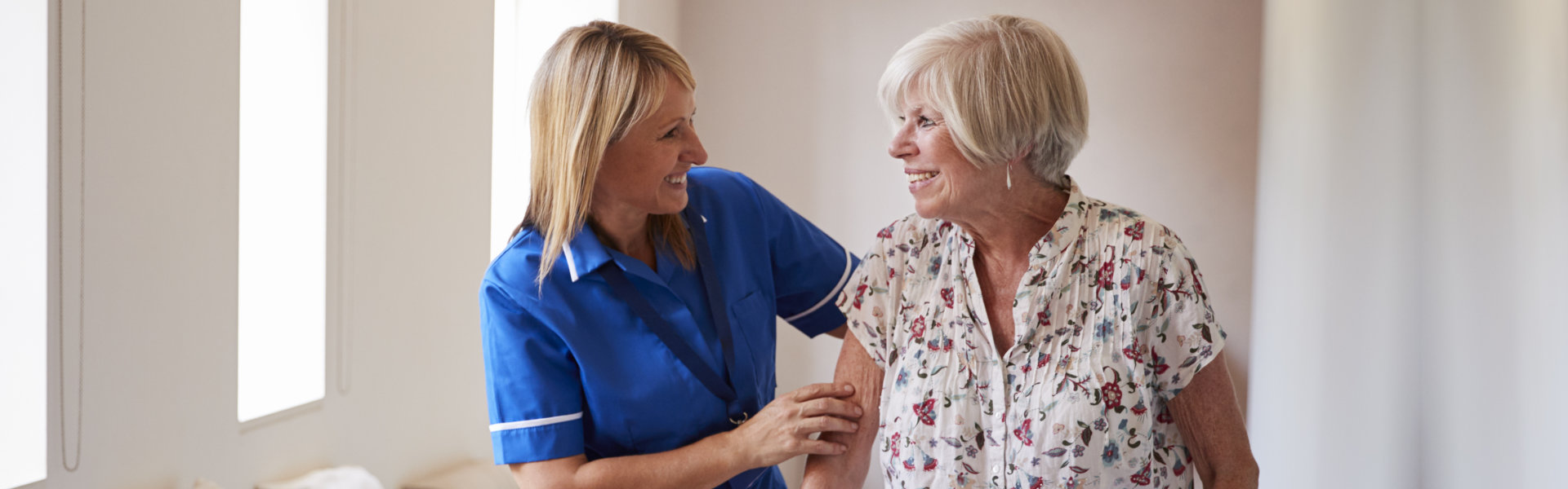 woman smiling to elderly woman