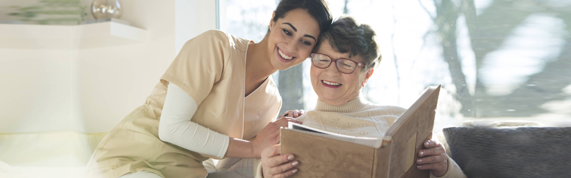 woman and elderly woman holding book