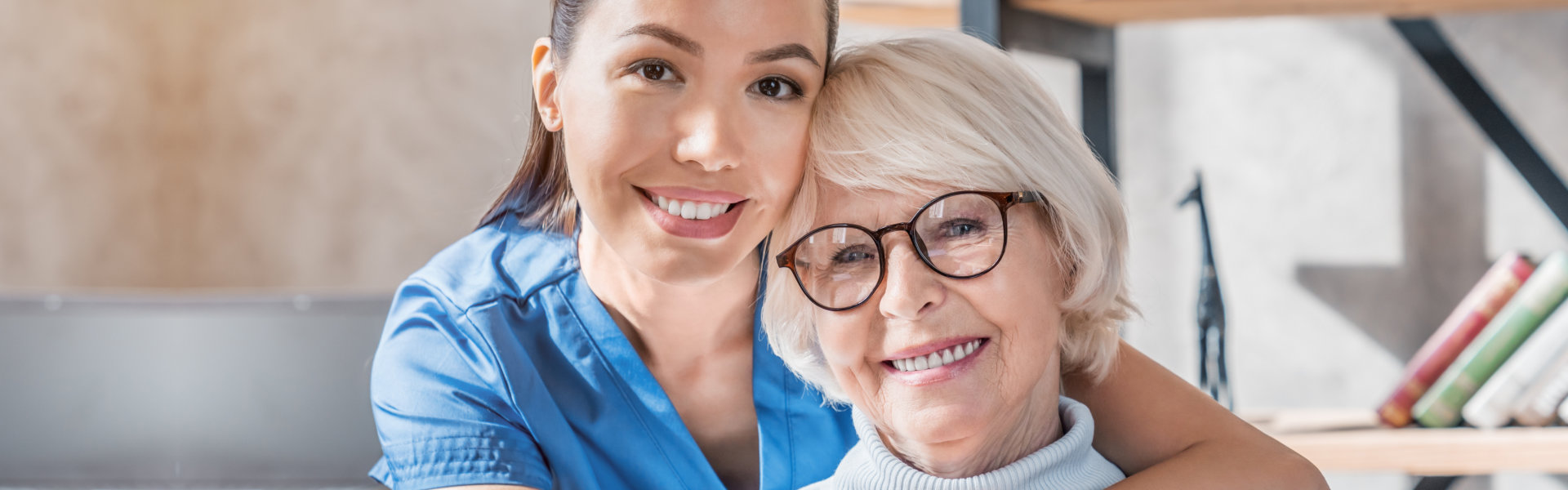 woman hugging elderly woman